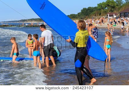 Zelenogradsk, Kaliningrad Region, Russia - July 29, 2017: Unknown Surfer With Surfboard Standing On 