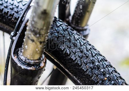 Washing Dirty Mountain Bike Suspension Fork After Riding In Bad Weather. Wet, Dirt And Oil Stains On