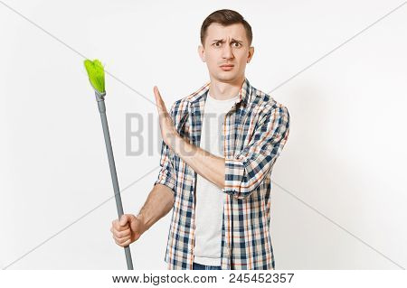 Unhappy Housekeeper Man In Checkered Shirt Holding And Sweeping With Green Broom Isolated On White B