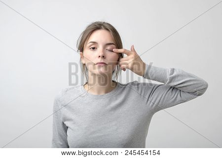 The Woman Is Touching Her Eye To Show That She Has Problem With Eyesight. Health Trouble. Concept Of