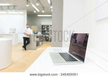 Laptop On The Showcase In The Technology Store. Laptop On The Background Of A Bright Modern Electron