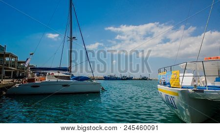 The old fishing boats are waving on the waves. Shipyard  in Limassol, Cyprus,  august 2017