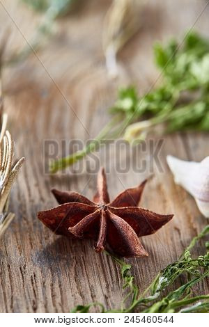 Anise Star, Parsley And Other Greenery On Wooden Background, Shallow Depth Of Field, Vertical. Natur