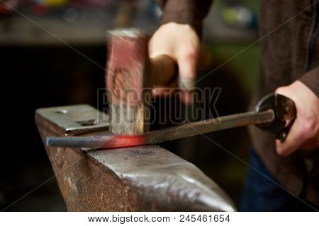 Close-up Of A Blacksmith's Hands Manipulating A Metal Piece Above His Forge, Selective Focus.