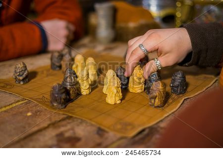 Close Up Shot - Two Men In Russian Ethnic Suit Playing Medieval Popular Strategy Board Game - Tafl. 