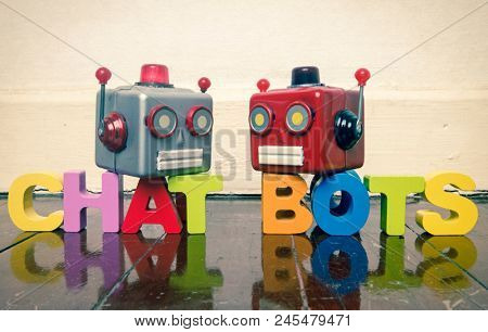 two talking heads with the word CHAT BOTS on a wooden floor with reflection 