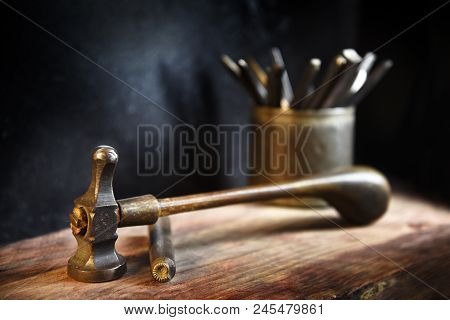 Vintage Hammer And A Hallmark Steel Punch, Jewelry Tools On A Rustic Wooden Workbench Of A Goldsmith