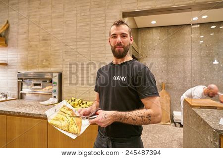 MILAN, ITALY - CIRCA NOVEMBER, 2017: indoor portrait of a man at Farini in Milan. Farini is modern bakery which offers Italian pastry, salads, bowls and pizza