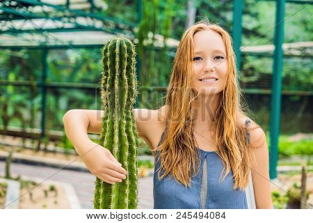 A Woman Hugs A Cactus As Her Best Friend. Problems Of Friendship Concept.