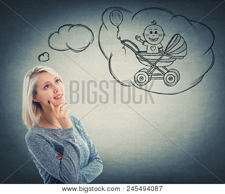 Portrait Of Thoughtful Woman Looking Up And Imagining A Baby In His Stroller. Dreaming Of A Child Wi