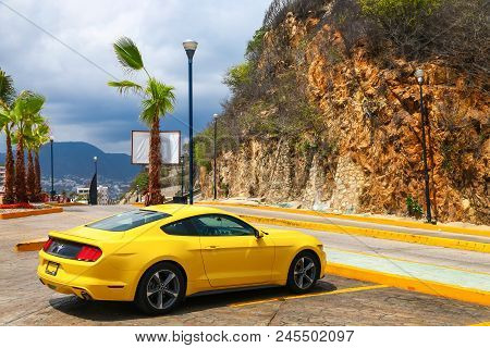 Acapulco, Mexico - May 31, 2017: Yellow Muscle Car Ford Mustang In The City Street.