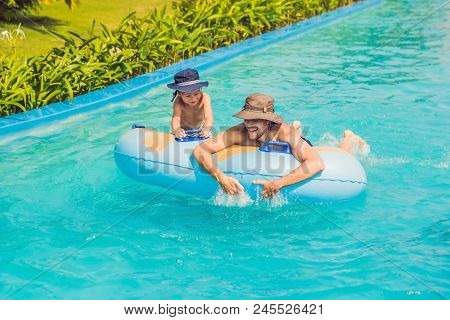 Father And Son Have Fun At The Water Park.