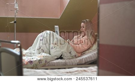 Patient Using Digital Tablet In Hospital Bed. Professional Shot In