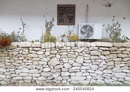 Fusion Of Old And New. The Old Rural Structure And The Modern Air-conditioner.