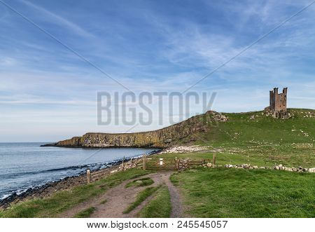 Beautiful Landscape Image Of Dunstanburgh Castle On Northumberland Coastline In England During Late 