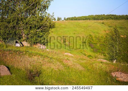 Small Tent On A Hill Ridge At Daylight Summer Andscape With Selective Focus