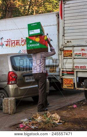 Unidentified Man Carryng Weight On His Head - A Boxes Full Of Fresh Fruits