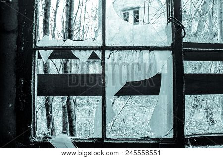 Cold Light Shines Through Broken Window At Lost Place