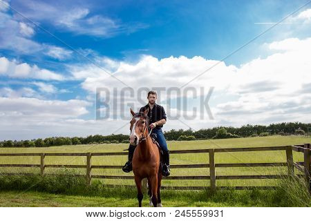 Good Looking, Hunky Cowboy Riding Horse With Boots, Chequered Shirt And Hat