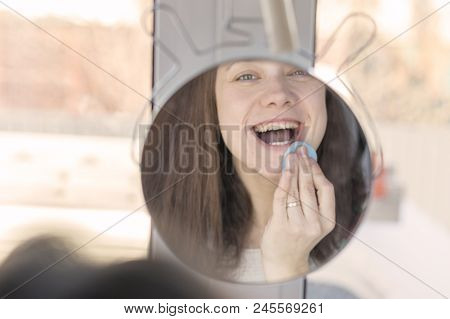 Beautiful Woman In Front Of The Mirror Make Up Herself.