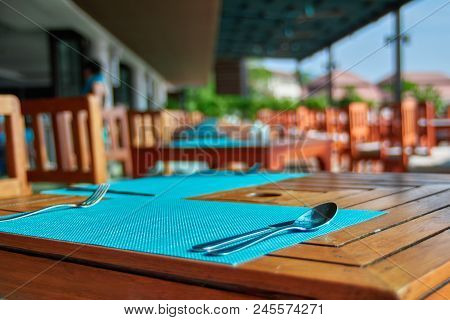 Cafe Table Setting With Spoon, Fork, Knife. Concept Dining In The Open Air. Prospect Of The Tables A
