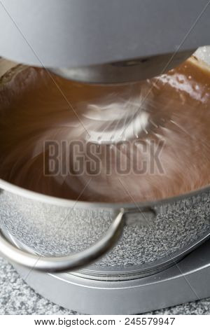 Mixer Blending Chocolate Cake Mix With Motion Blur On Kitchen Top