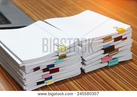 Close Up Pile Of Unfinished Paperwork Separated By Colorful Binder Clips On Office Desk Waiting To B
