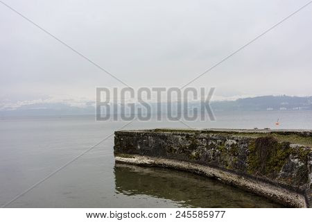 Stone Harbour At Lake In Winter With Snow Mountain