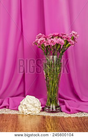 White Airy Bisex On The Background Of A Bouquet Of Pink Forget-me-nots And Pink Cloth