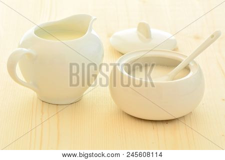 Soft White Creamer And Sugar Bowl On Natural Pine Background. In Horizontal Format And Shot In Natur