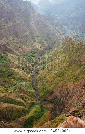 Breathtaking View Of Canyon With Steep Cliff And Winding Riverbed With Lush Green Vegetation On Delg