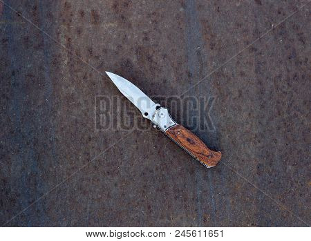 Folding Knife On Rusty Metal Background, Close Up, Folding Knife