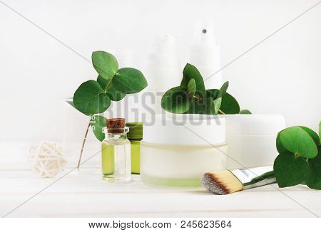 Set Of Bottles And Jars With Natural Cosmetic Products For Skin Care. White Tones, Green Fresh Leave