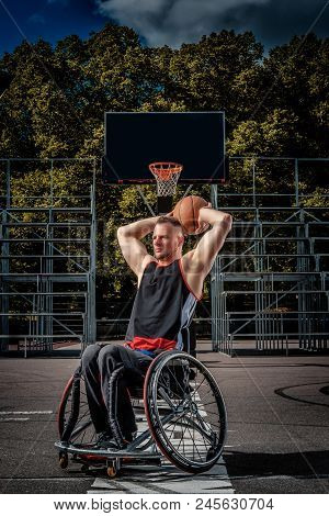 Cripple Basketball Player In A Wheelchair Plays On An Open Gaming Ground.