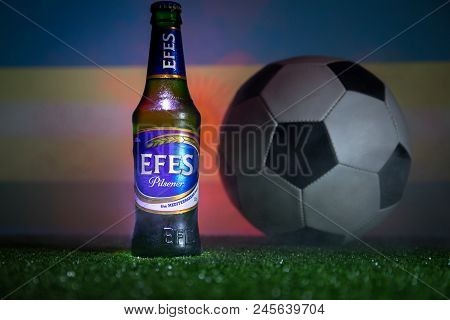 Baku,azerbaijan - June 15, 2018 : Bottle Of Efes Pilsner Beer On Grass With Soccer Ball And Blurred