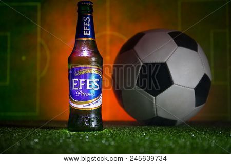 Baku,azerbaijan - June 15, 2018 : Bottle Of Efes Pilsner Beer On Grass With Soccer Ball And Blurred