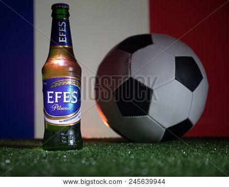 Baku,azerbaijan - June 15, 2018 : Bottle Of Efes Pilsner Beer On Grass With Soccer Ball And Blurred
