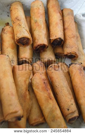 Vertical Shot Of Cooked Lumpia Egg Rolls On White Napkin