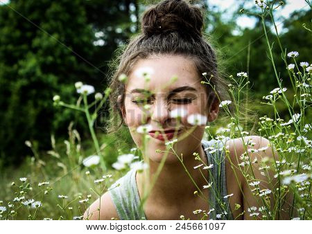 Young Woman Scrunching Her Nose In A Field.