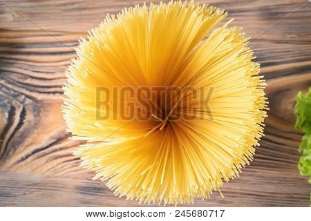 Food Background Uncooked Pasta Macaroni Spaghetti Cappellini On Background Wooden Table Concept Ingr