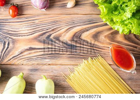 Food Background Uncooked Pasta Macaroni Spaghetti Cappellini On Background Wooden Table Cherry Tomat