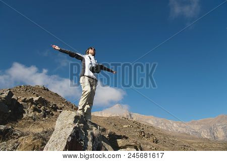 An Applause Of A Young Woman Backpacker On Top Of A Sprawling Upward Mountain Peak. Freedom And Vict