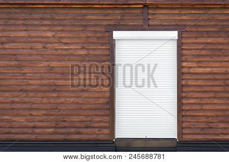 Wooden Building Facade. Brown Wood Siding Wall With White Shutter Door. Copyspace.