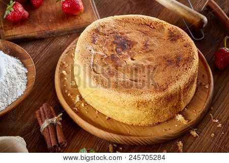Top View Raw Ingredients For Cooking Strawberry Pie Or Cake On Wooden Table: Eggs, Sugar And Strawbe