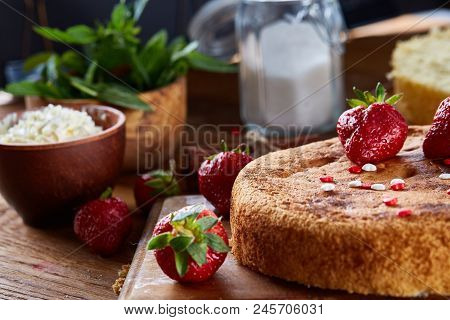 Top View Raw Ingredients For Cooking Strawberry Pie Or Cake On Wooden Table: Eggs, Sugar And Strawbe
