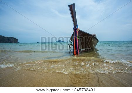 Long Tail Boat With Small Waves On The Beach