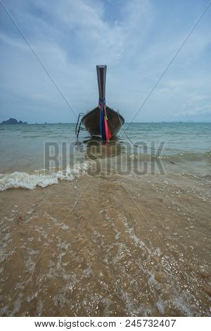 Long Tail Boat On Shore With Small Waves