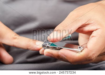Close Up Shot Of Man Cutting Nails