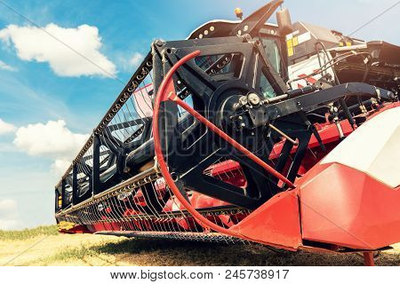 Combine Harvester Draper Head Closeup Against Blue Sky
