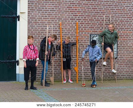 Urk, Netherlands - May 19, 2018: Unknown Children Walking Stalks On The Annual Urkerdays. Urk Is On 